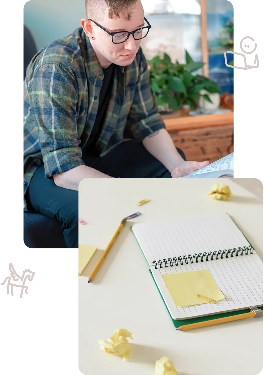 Lewis Jorstad holding a book, beside an open notebook with crumpled paper